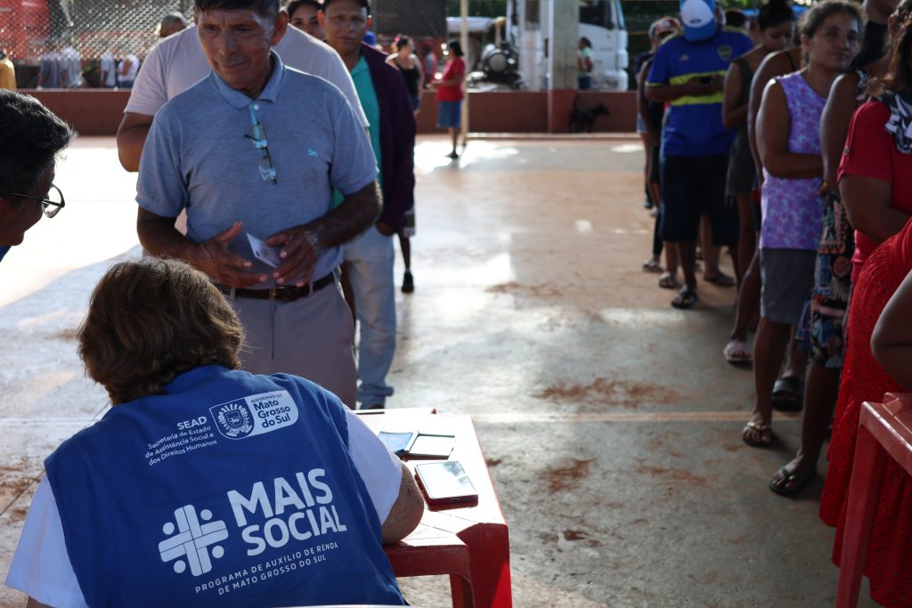 Indígenas em fila pegando senha com servidora do Mais Social